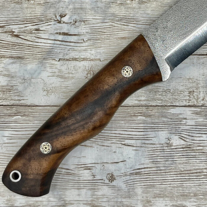 Rustic outdoor camping knife with a durable wooden handle, perfect for wilderness adventures and outdoor activities.